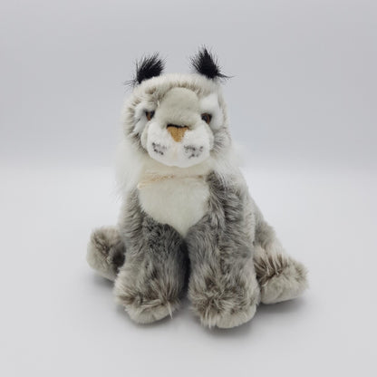 A fluffy grey lynx soft toy sitting upright