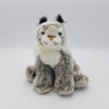 A fluffy grey lynx soft toy sitting upright