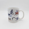 A white ceramic mug featuring watercolour designs of  grey ring-tailed lemurs and small monkeys.