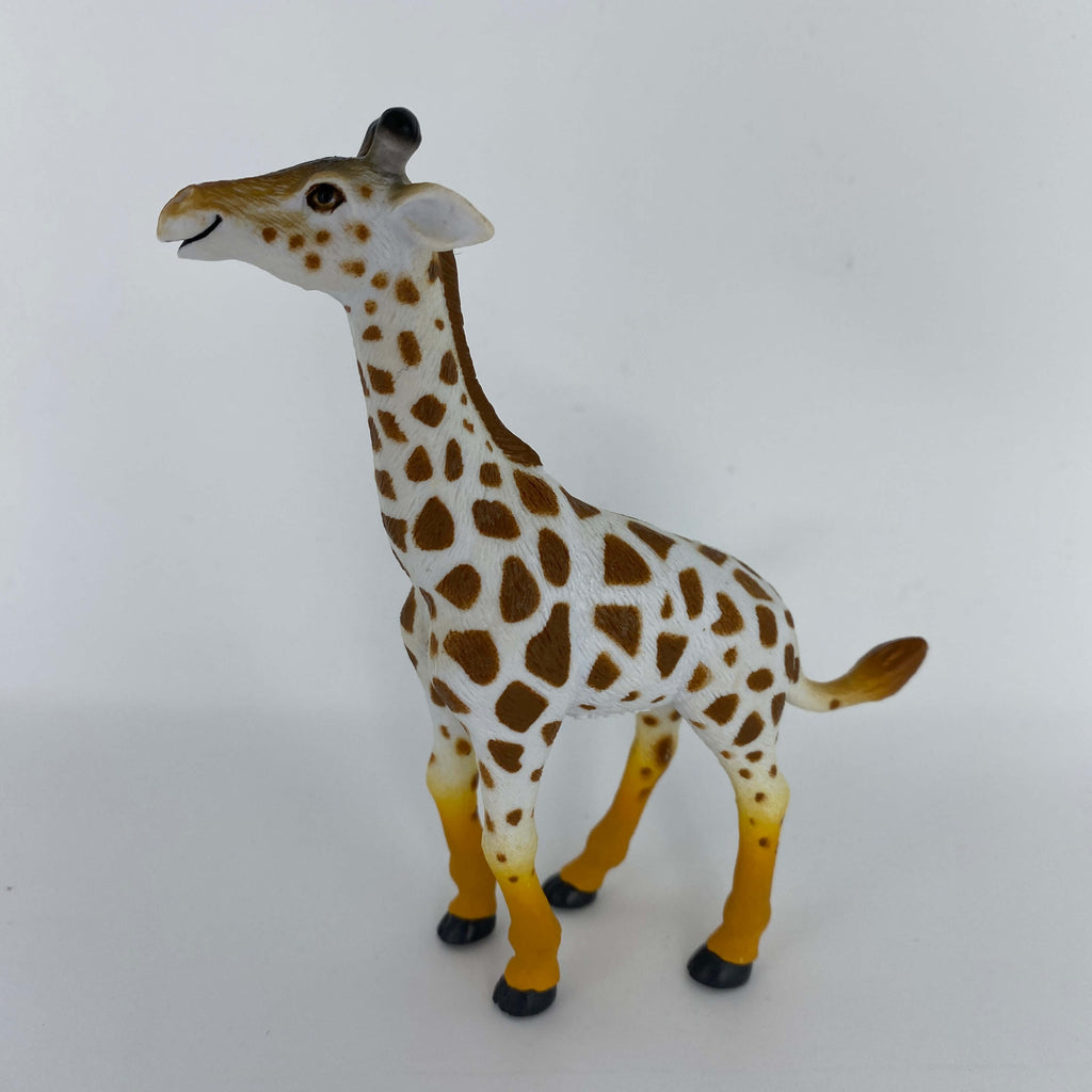 A side view of a plastic giraffe toy