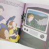 A picture of an inside page of the book "David Attenborough. Little People, Big Dreams", showing a family watching David Attenborough on TV.