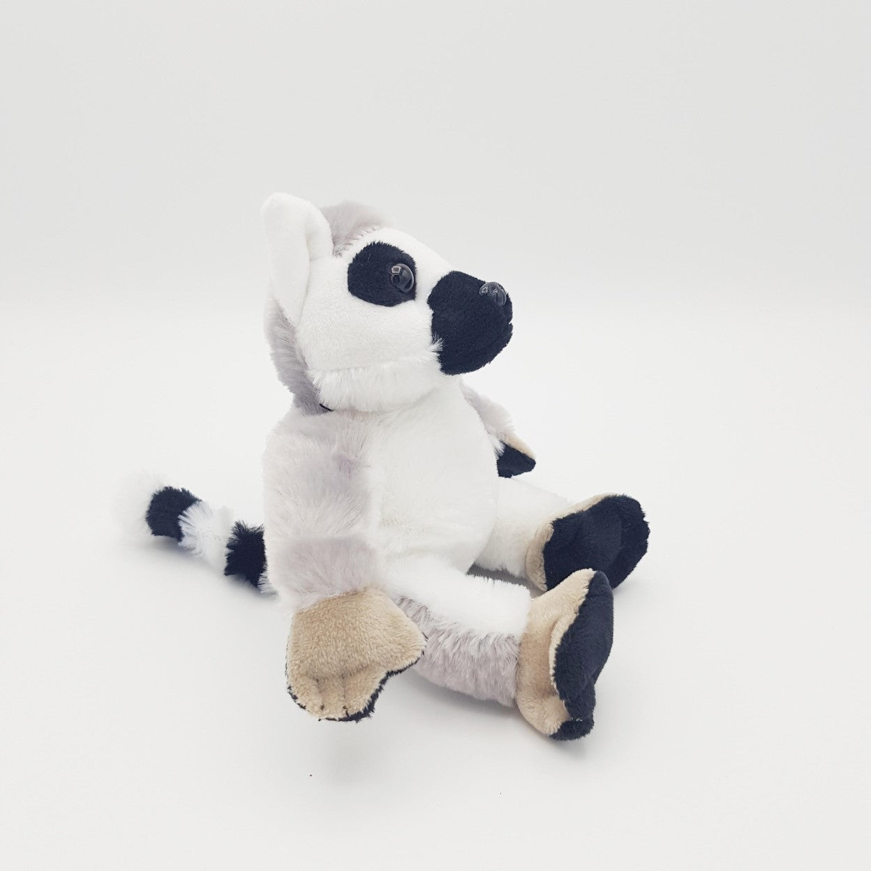 The side of the toy, with a black face, white belly and white ears