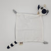 Ring-tailed lemur blanket comforter laid flat. Square blanket with soft white fur, small arms and black and white tail and head.