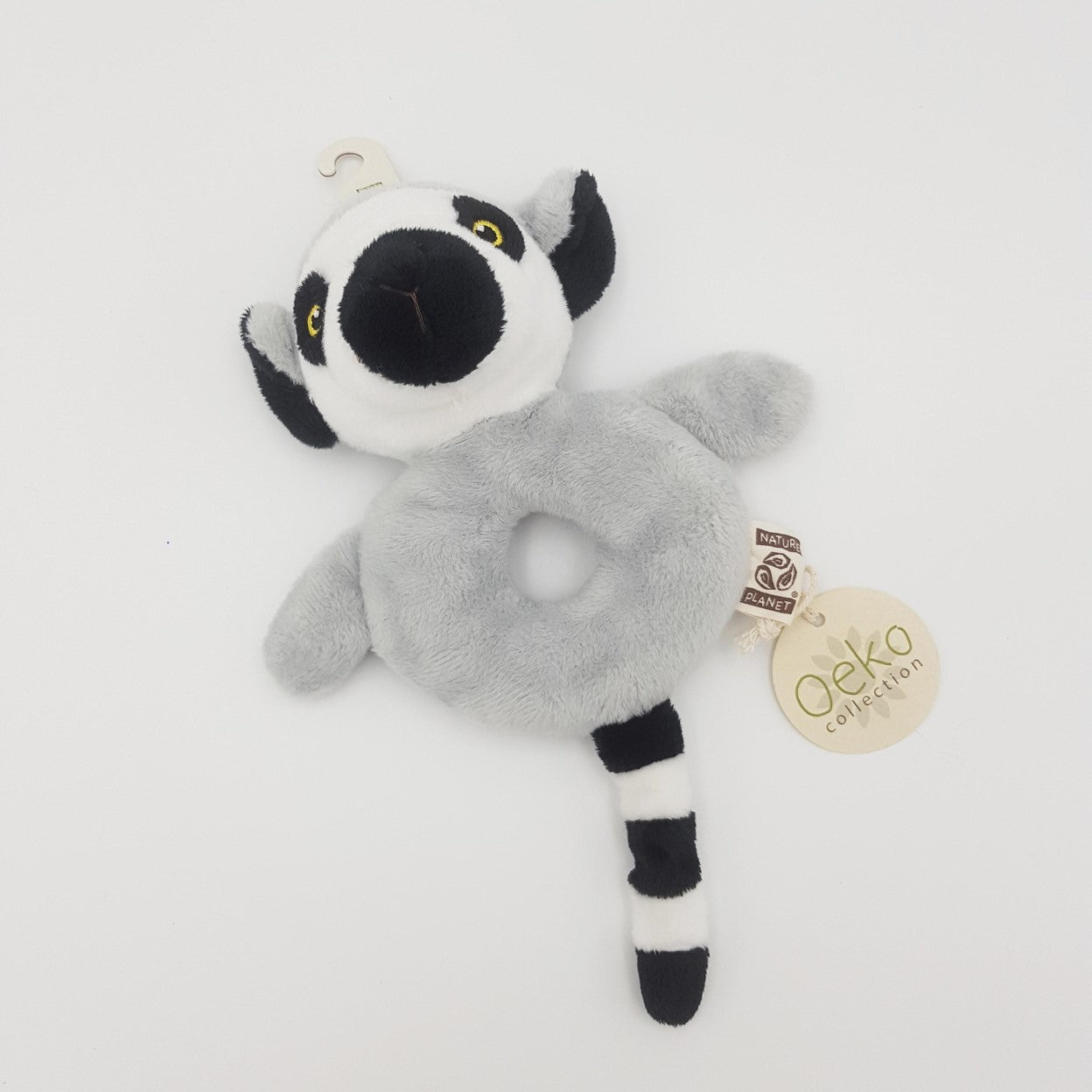 Soft toy ring-tailed lemur rattle with hole in the middle, a lemur's head at the top, tail at the bottom and grey fur.