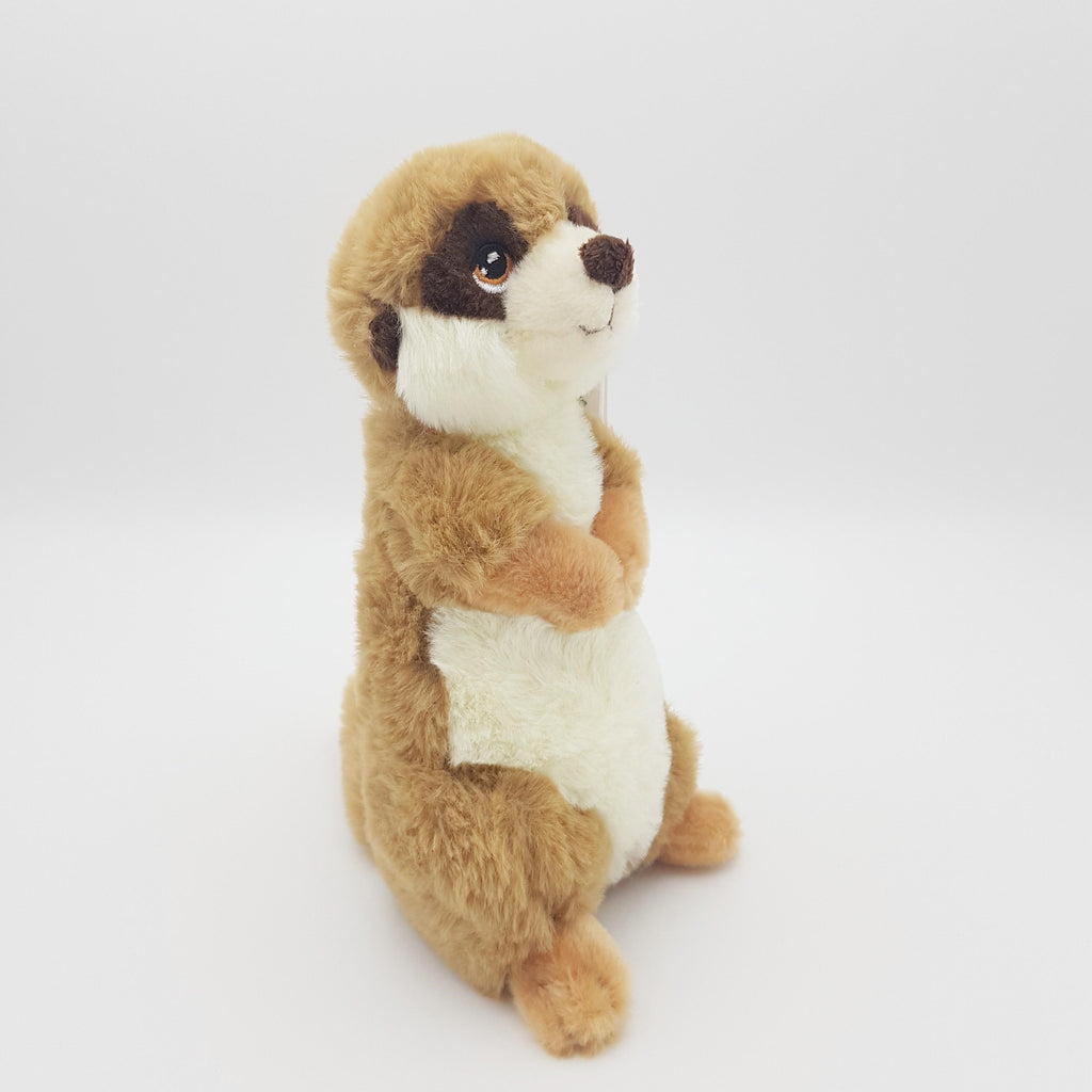 The side profile of a meerkat eco soft toy, with a white belly, brown eyes and tanned back, sat upright