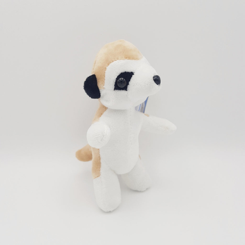 A small meerkat eco soft toy, with a white belly, black eyes, tanned back and black ears.